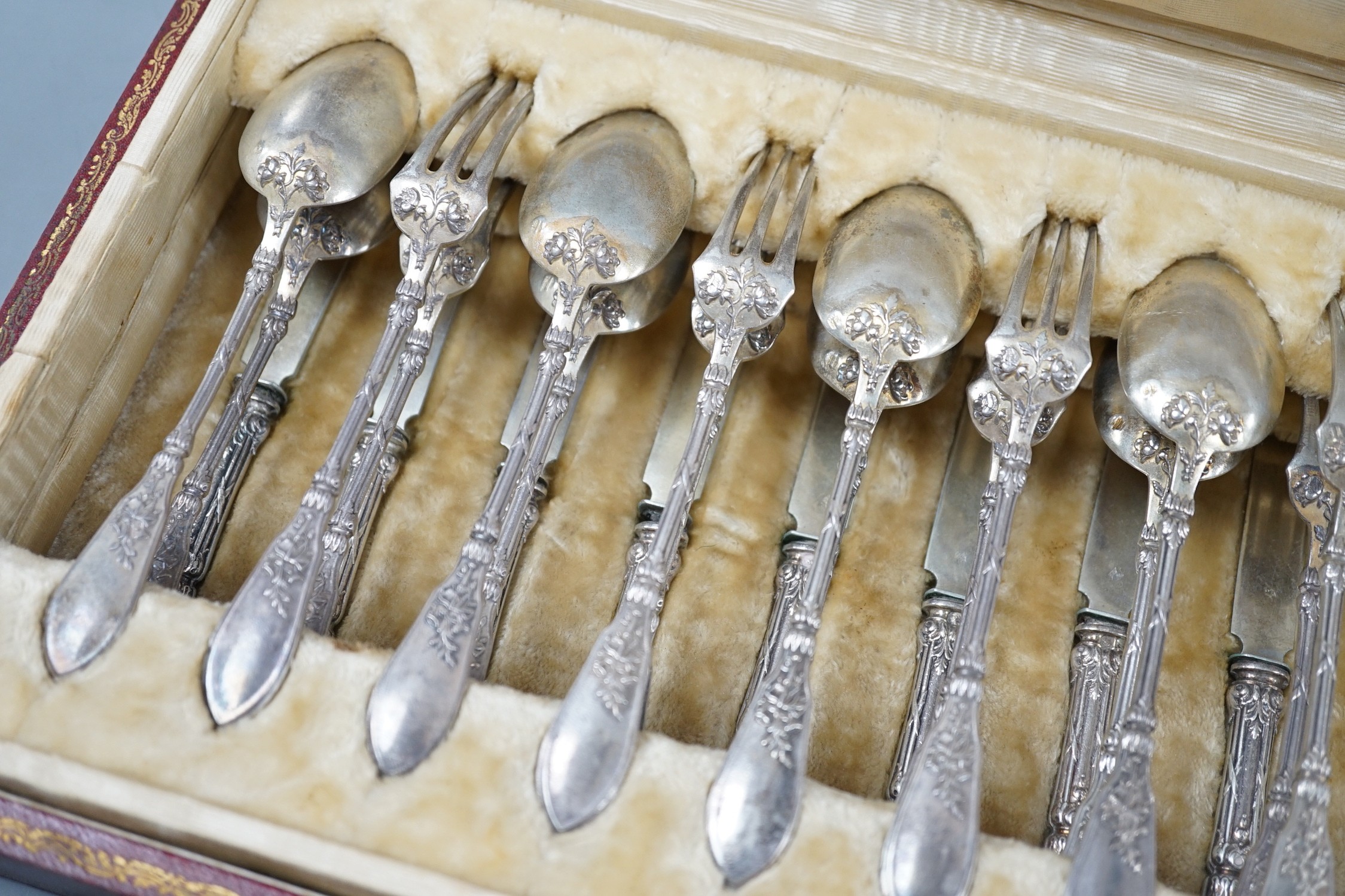 An early 20th century cased set of twelve French 950 standard white metal tea knives, spoons and forks, by Henin & Vivier and Henin & Cie?, retailed by Charles Pellegrin, spoon 14.1cm, 20oz.